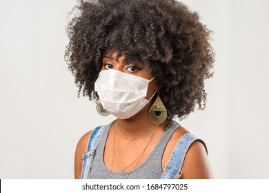 Black Teenage Girl Wearing Face Mask Looking At Camera