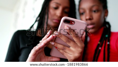 Similar – Sisters, teenage girl and her younger sister pushing hay bale playing together outdoors in the countryside