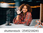 A Black teenage student explores a robotic arm in a classroom experimenting and learning about subjects of interest. Embracing innovation and technology for skill development in education.