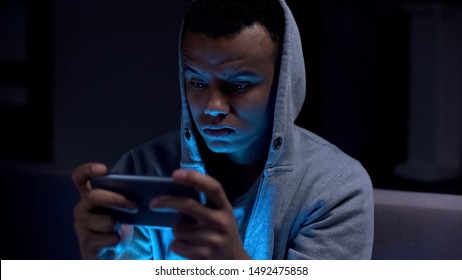 Black Teenager Playing Video Games On Phone, Harm For Mental Health And Eyesight