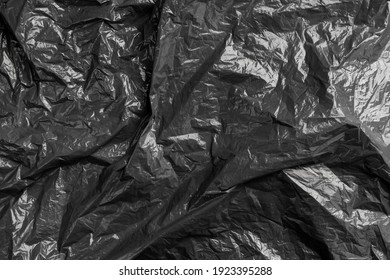 Black Texture Of Crumpled Wrinkled Garbage Plastic Bag. Abstract Background