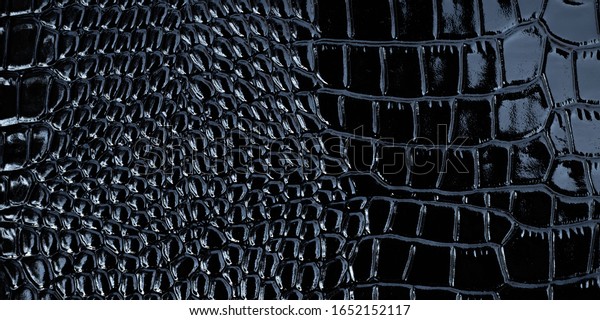 Black texture of patent leather, crocodile\
pattern, abstract background of snakeskin print, clothes. Textile\
design, material of fashion accessory.\
