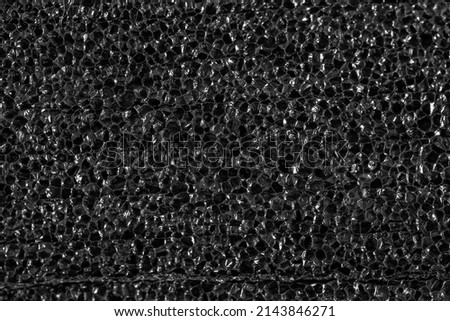 Black texture of porous packaging material.
