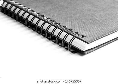 Black, textured on spiral notebook isolated on white background.