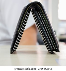 Black Thick Wallet On Wooden Table