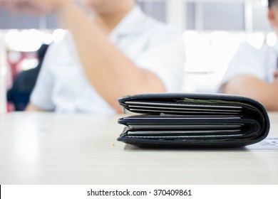 Black Thick Wallet On Wooden Table