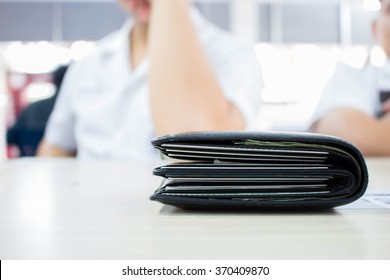 Black Thick Wallet On Wooden Table