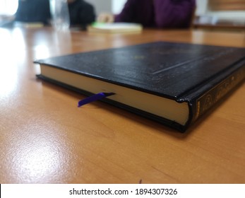 Black Thin Book Standing On The Table