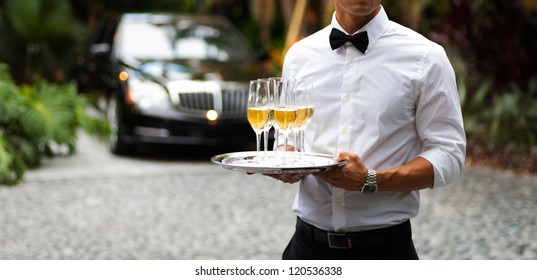 Black Tie Waiter Serving Champagne Outdoors.