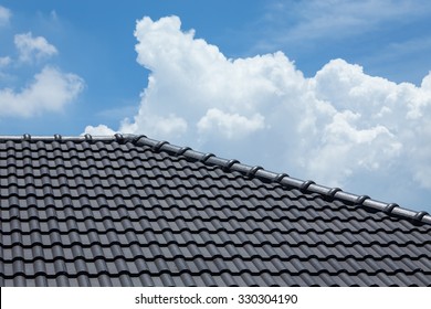 Black Tile Roof Of Construction House With Blue Sky And Cloud Background