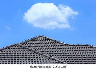 Black Tile Roof On A New House With Blue Sky