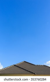 Black Tile Roof On A New House With Clear Blue Sky Background