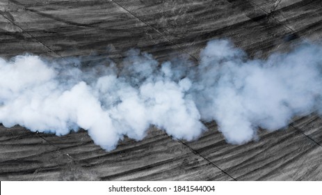 Black tire marks and white smoke on asphalt race track, Road dust cloud from driving car, Combustion fumes of car exhaust pipe, The engine is not working properly.