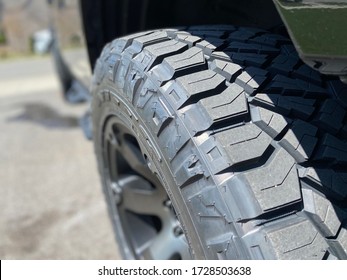 Black Tire On A Pick Up Truck With Custom Rims.