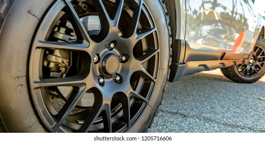 Black Tire Rim And Disc Brake Of A Shiny White Car