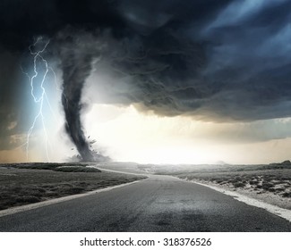 Black tornado funnel and lightning on road