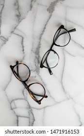 Black And Tortoise Shell Glasses On Marble Background, Copy Text Space