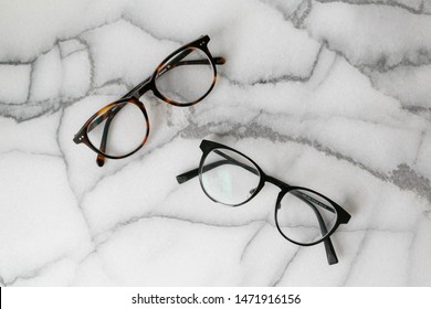 Black And Tortoise Shell Glasses On Marble Background, Copy Text Space