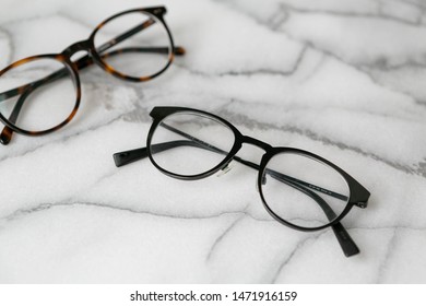 Black And Tortoise Shell Glasses On Marble Background, Copy Text Space