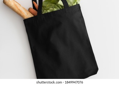 Black Tote Bag Mockup With Groceries On A White Table.