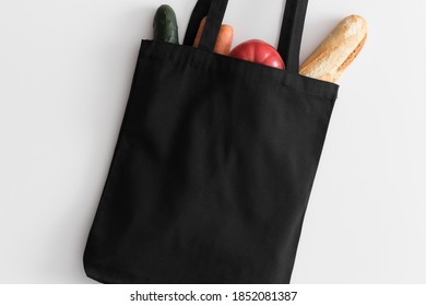 Black Tote Bag Mockup With Groceries On A White Table.