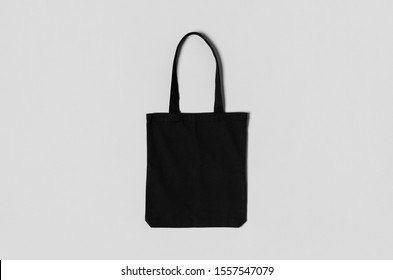 Black tote bag mockup on a grey background. - Shutterstock ID 1557547079
