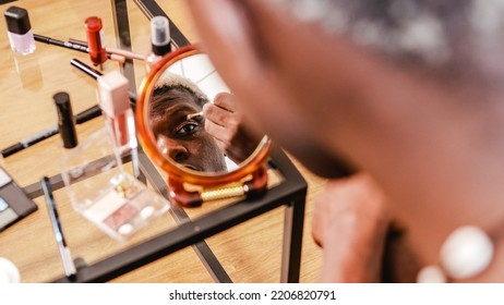 Black Transgender Man Applying Makeup