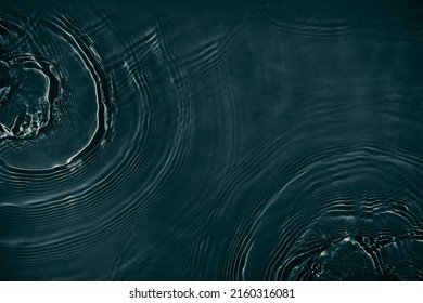 Black transparent clear calm water surface texture with ripples, splashes Abstract nature background. Dark grey water waves in sunlight Copy space top view Cosmetic moisturizer micellar toner emulsion - Shutterstock ID 2160316081