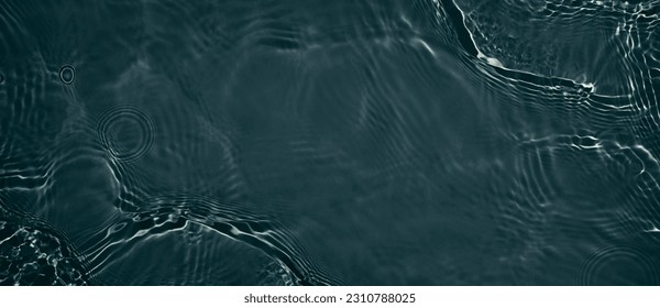 Black transparent clear calm water surface texture with ripples, splashes. Abstract nature banner background. Dark grey water waves. Copy space, top view. Cosmetic moisturizer micellar toner emulsion - Shutterstock ID 2310788025
