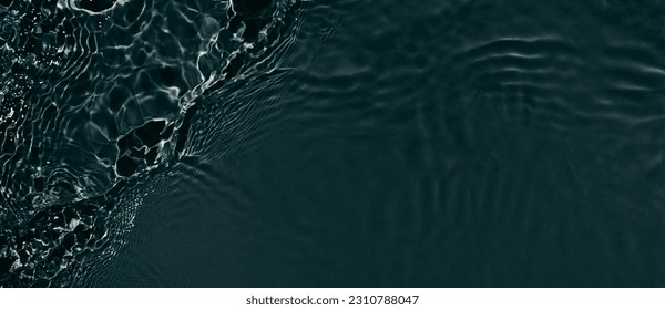 Black transparent clear calm water surface texture with ripples, splashes. Abstract nature banner background. Dark grey water waves. Copy space, top view. Cosmetic moisturizer micellar toner emulsion - Shutterstock ID 2310788047