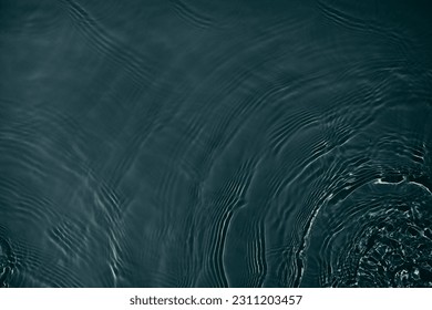 Black transparent clear calm water surface texture with ripples, splashes Abstract nature background. Dark grey water waves in sunlight Copy space Cosmetic moisturizer micellar toner emulsion - Shutterstock ID 2311203457