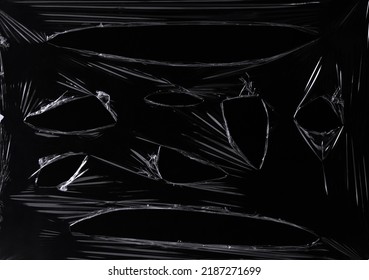 a black transparent plastic texture with hole for poster and cover art. realistic plastic wrap for overlay, copy space and photo effect. wrinkled plastic surface on black background