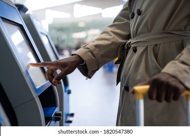 Black Traveler Man Using Self Check-in Machine Kiosk Service At Airport, Finger Point On Display. Close Up. 