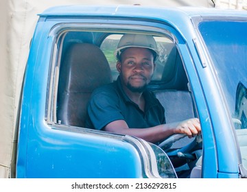 Black Truck Driver Smiling Wearing A Helmet