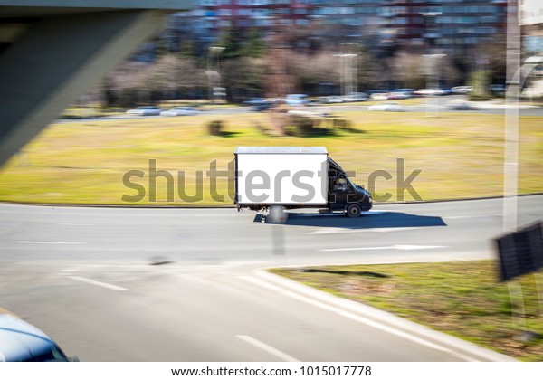 black truck with white body moving at high\
speed. blurring effect. panning. a fast-moving truck with the\
ability to place an optional label on\
it.