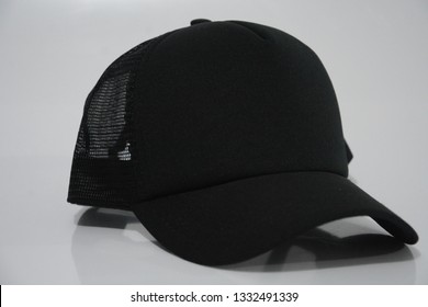 A Black Trucker Cap In A White Background.