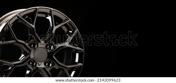 black tuning sports alloy\
wheel fragment detail on a black background copyspace copy space\
panorama