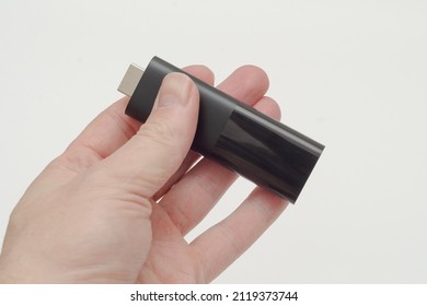 black tv box stick in hand on white background - Shutterstock ID 2119373744