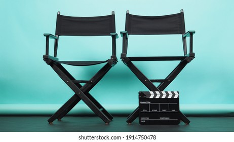 BLACK two director chair with Clapperboard or movie Clapper board on green or Tiffany Blue and black floor background.it use in video production or movie and cinema industry. 
