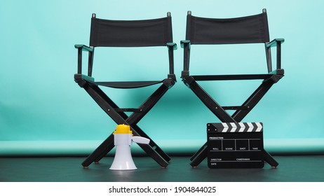 BLACK two director chair with megaphone and Clapperboard or movie Clapper board on green or Tiffany Blue and black floor background.it use in video production or movie and cinema industry. 