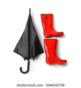 Black Umbrella And Gumboots On White Background