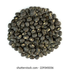 Black urad dal lentil beans in a bile isolated against white