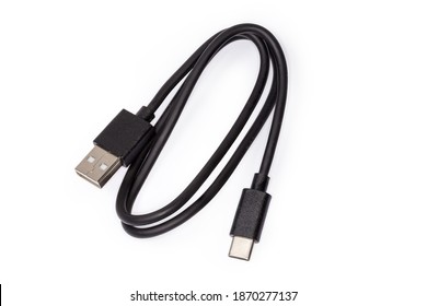 Black USB cable with plugs type A and type C at the edges on a white background 