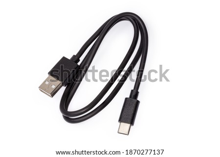 Black USB cable with plugs type A and type C at the edges on a white background 
