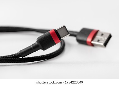 Black USB Type-C flex cable for electronic devices. Close-up, studio shot.