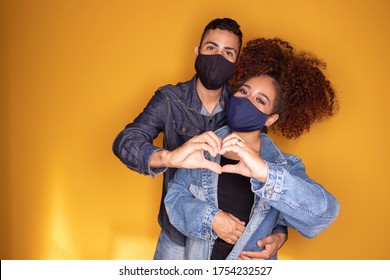 Black valentine couple with mask on yellow background. Covid-19