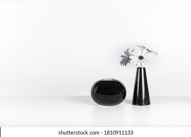 Black Vase With White Flowers And Black Candle Holder