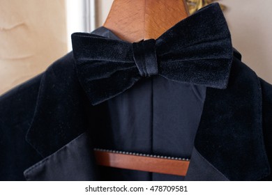 Black Velvet Bow Tie And Jacket Hang On The Wooden Peg