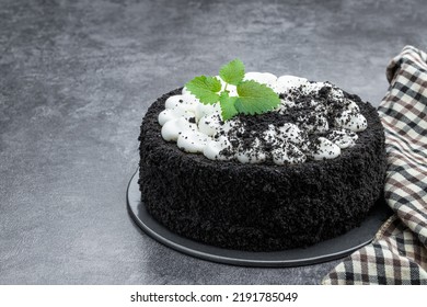 Black  Velvet Cake Decorated With White Cream On Gray Stone Background 