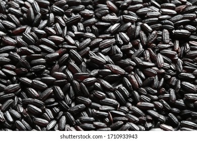 Black Venus Integral Rice Grains closeup background texture, macro photography from above